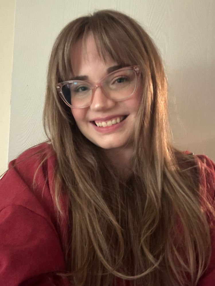 a picture of me showing off my new hair cut with sabrina carpenter style bangs and a dark blonde balayage 