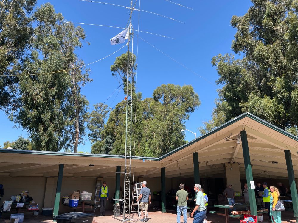Park shelter with folks busy tearing down the Field Day radio station. 
