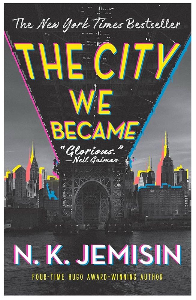 Color illustration of a city skyline viewed from beneath a bridge, with book title “The City We Became” on the underside of the bridge. By N.K. Jemisin.