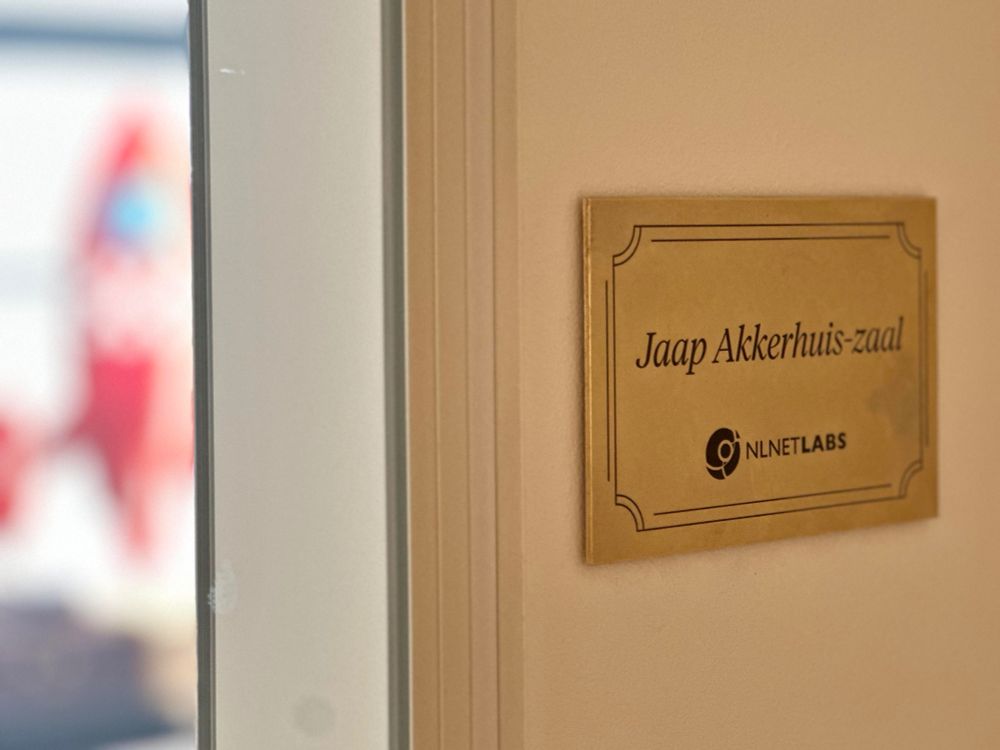 A bronze plaque that reads "Jaap Akkerhuis-zaal" in the NLnet Labs' office.