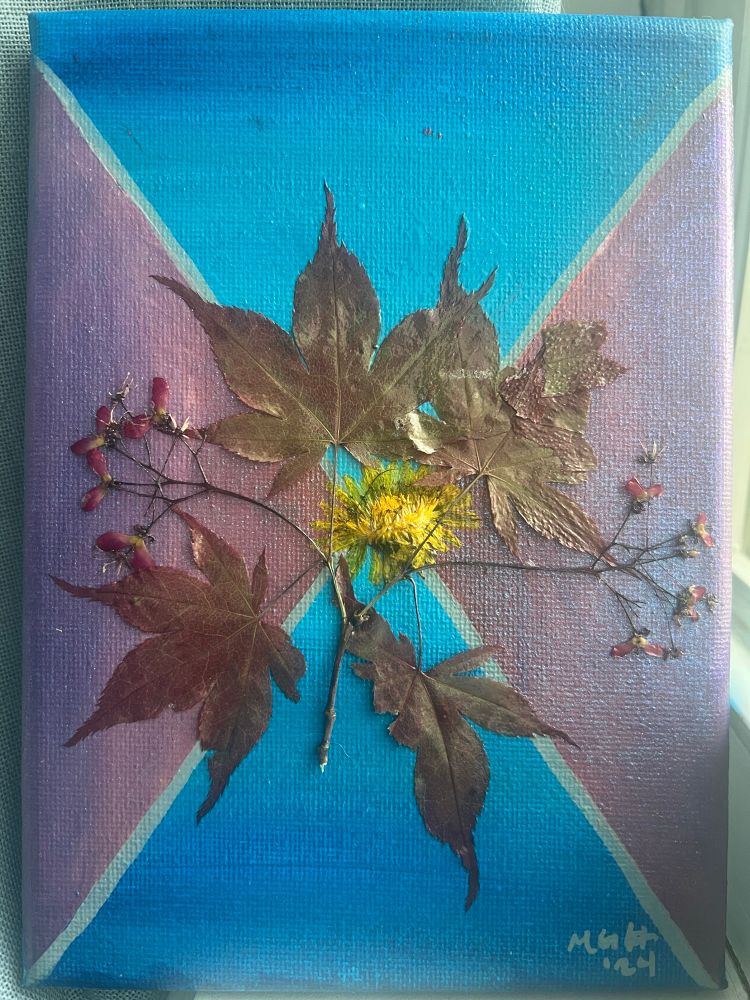 Artwork, acrylic on canvas, background of blue and purple. Overlayed with Pressed Japanese maple leaves and dandelion. 
