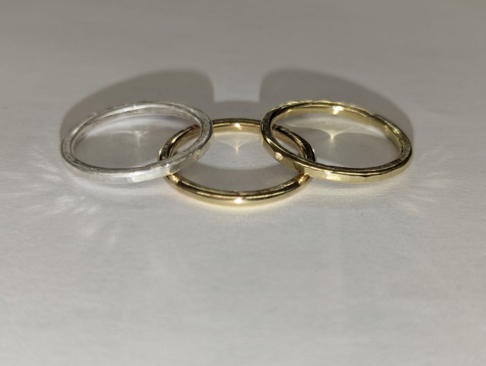 Two brass rings & one silver ring. They are very shiny.