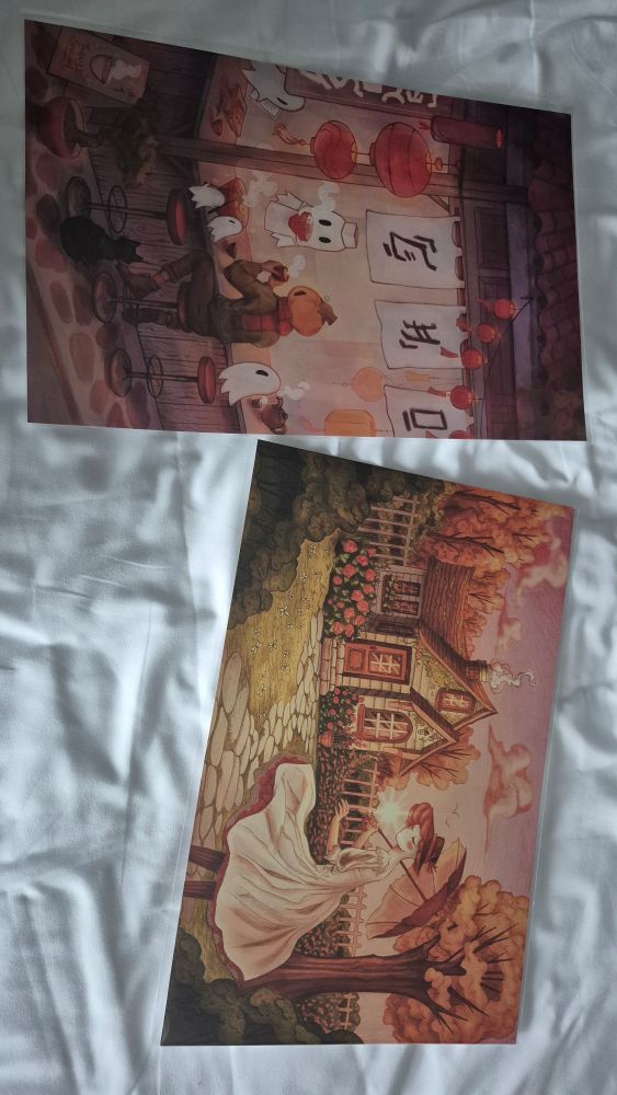 Two prints of spooky themed original characters from Dokidokon's Vendor hall.