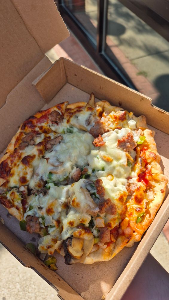 A small, supreme pizza from a local pizzeria.