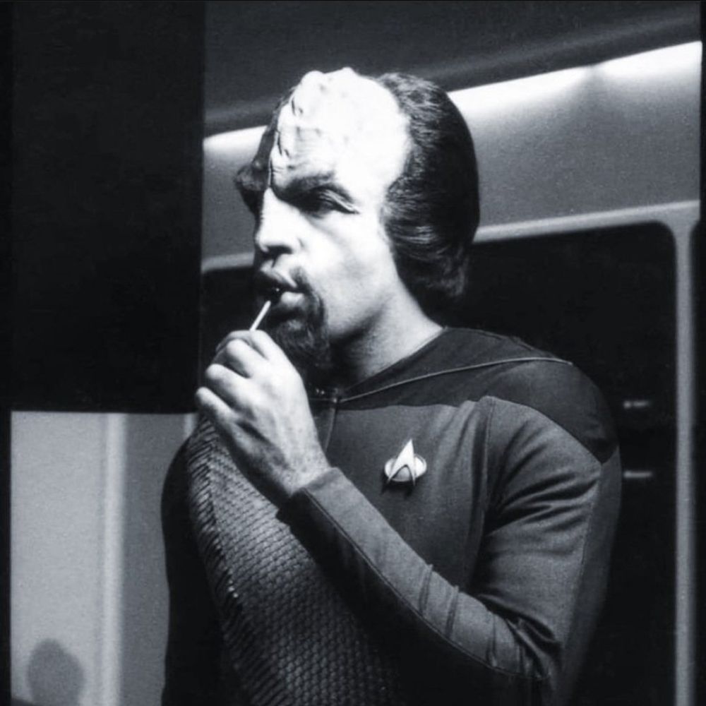 Black and white photo of early TNG Worf enjoying a sucker 
