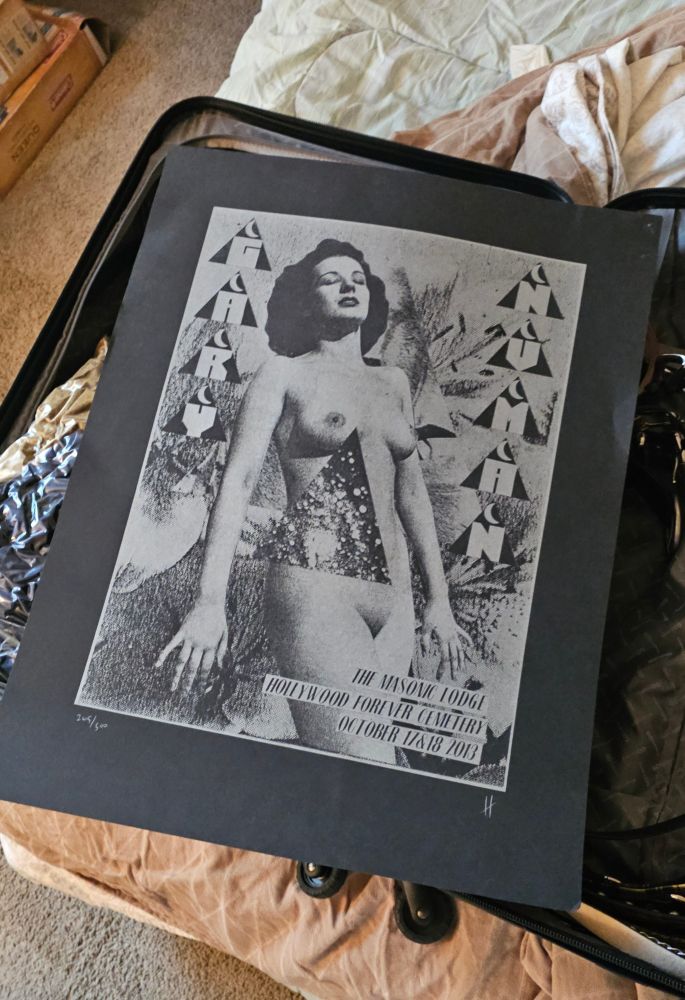 A vintage nude lady in silver on black with Gary Numan tour info