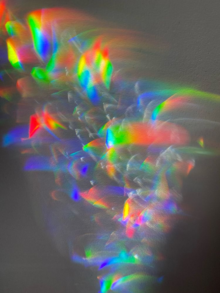 A jumble of rainbow flashes on a dark wall. 