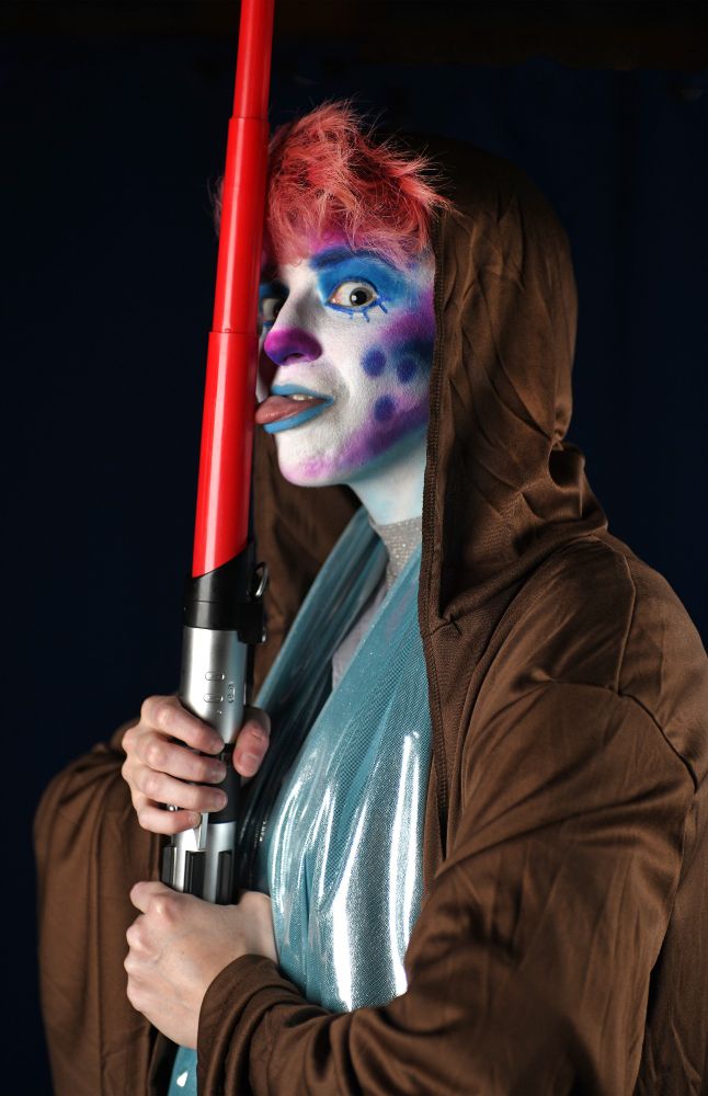 Captain Dick licking a red lightsaber.