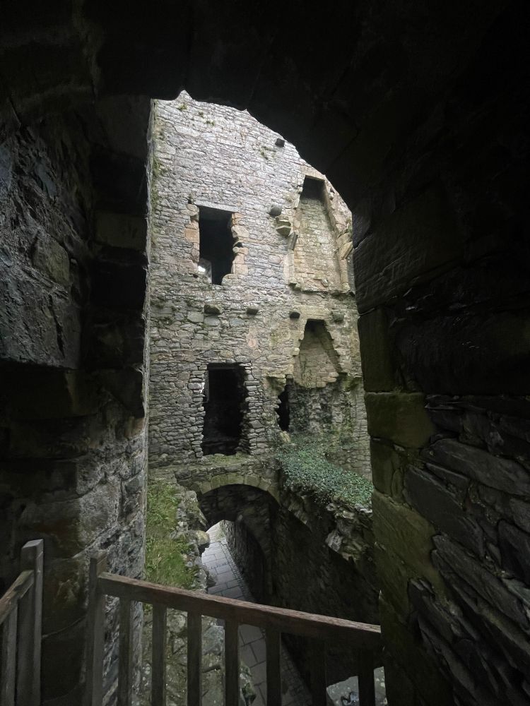Castle gate interior of 750 y.o. Harlech Castle ruins in Wales. Shows old chimneys and doorways.