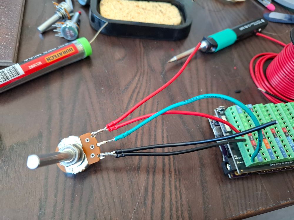 A potentiometer wired into the terminal blocks mounted to the microcontroller board.