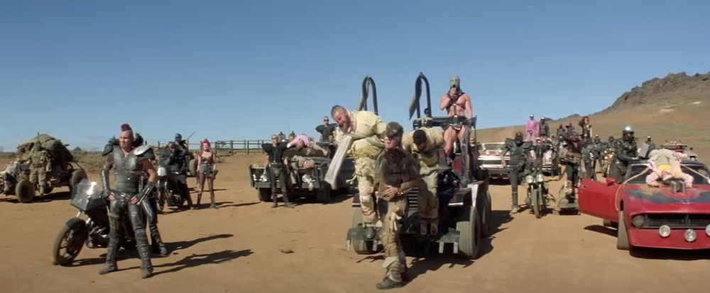 still from Mad max 2 showing outlandish post apocalyptic vehicles and costumes.