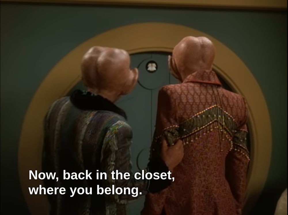 Screenshot from the Star Trek: Deep Space Nine episode Ferengi Love Songs. Quark pushes Brunt towards a round closet door. The subtitle says "Now, back in the closet, where you belong."