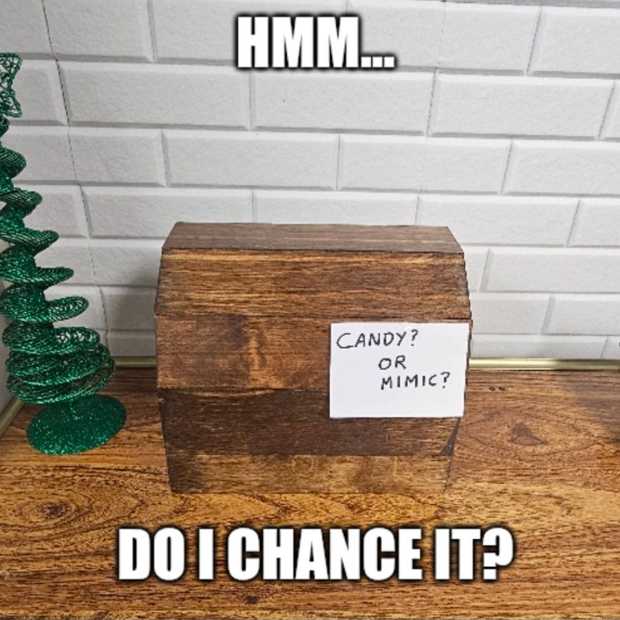 A closed wooden box with a note reading "Candy? Or Mimic?" with the caption "Hmm... do I chance it?"