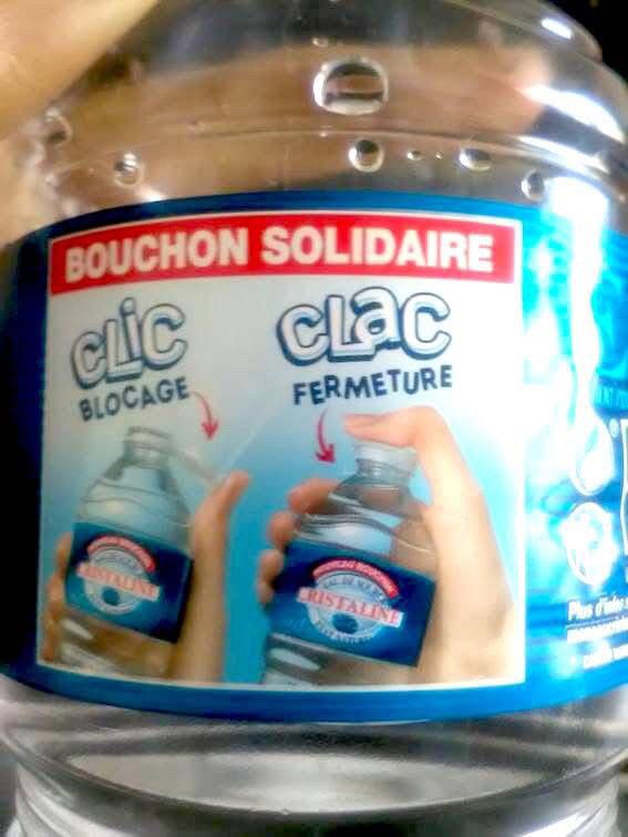 étiquette de bouteille d'eau Cristalline. Il y a la photo. du mouvement de pouce qui ouvre le bouchon et c'est écrit "CLIC - BLOCAGE". Quand on referme le bouchon avec le pouce, c'est écrit "CLAC FERMETURE"