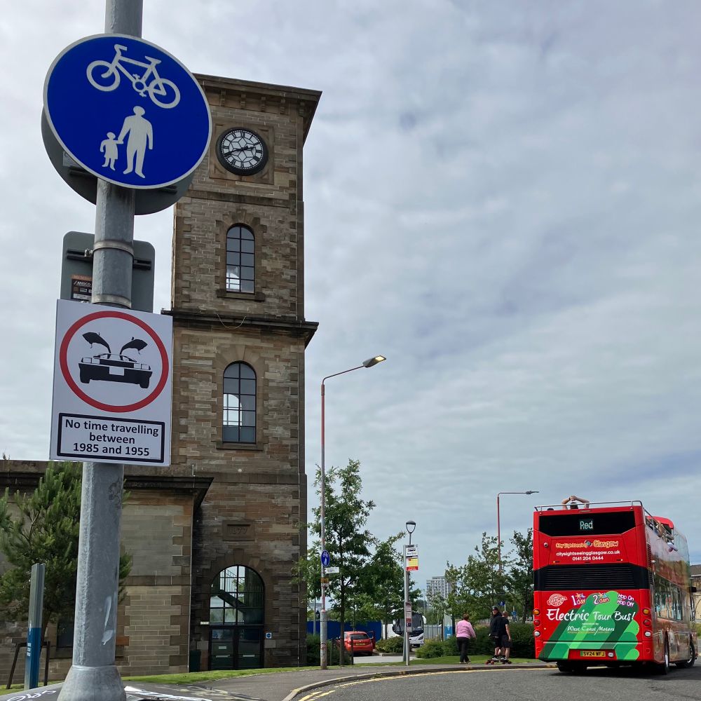 View of Clydeside Distillery - sign on pole with image of DeLorean car says: “No time travel between 1985 and 1955”