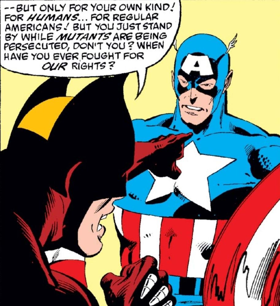 A close-up of Wolverine and Captain America. Wolverine, now pointing an accusatory finger at Captain America, has an intense, angry expression. Captain America remains silent, his face solemn. Wolverine continues his speech: "—But only for your own kind! For humans... for regular Americans! But you just stand by while mutants are being persecuted, don’t you? When have you ever fought for our rights?" Captain America looks troubled but does not respond.
