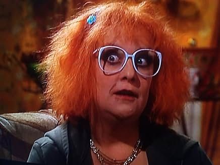 Linda la Hughes, a character from the sit com 'Gimme Gimme Gimme'. Linda has untidy died red hair and big white eyeglasses.