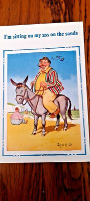 Seaside postcard by Donald McGill, date 1963. Next to the sea, a fat middle-aged man is astride a donkey, white cliffs(or poss. a building) and a boat in the distance, another fatty is sitting on the sand. The caption: "I’m sitting on my ass on the sands" refers to both characters.