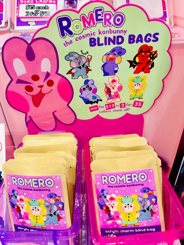 Close up of my booth featuring a blind bag display of cartoon bunnies in different costumes 