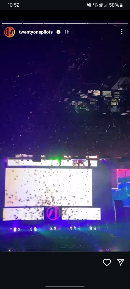 a screenshot of an instagram story from the twenty one pilots account. its an upside down recording of the concert