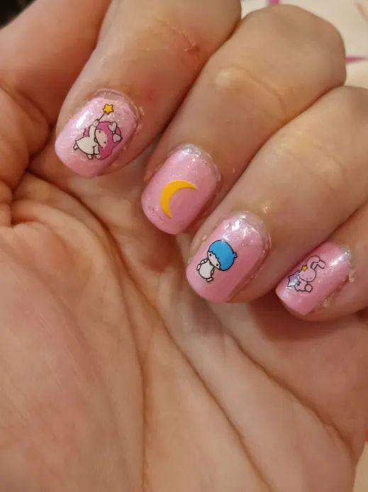 A pink pearlescent manicure with Saniro "Little Twin Stars" decals.
