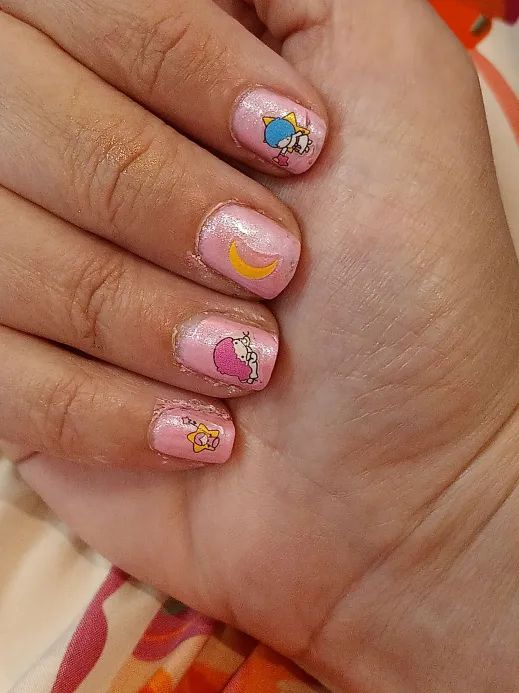 A pink pearlescent manicure with Saniro "Little Twin Stars" decals.