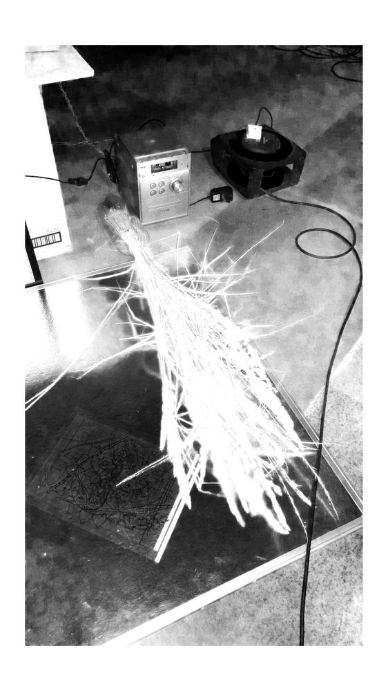 black and white photograph of electrical cables, a stereo, organic material obscure