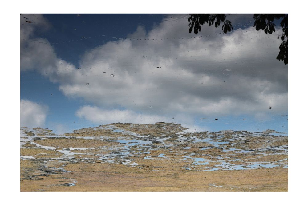 colour photograph of a landscape with clouds