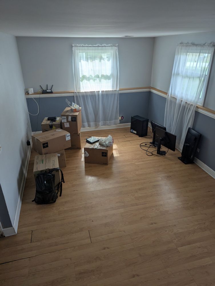 Boxes, monitors and a computer on the floor