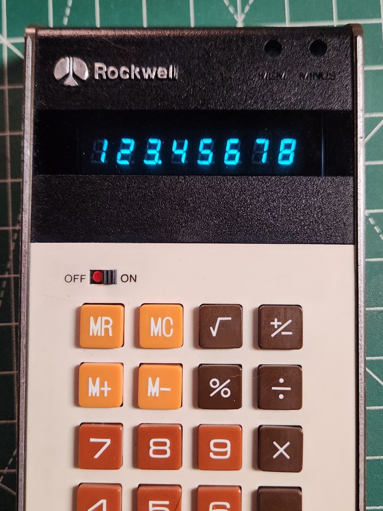 Calculator with VFD display showing number 123.45678