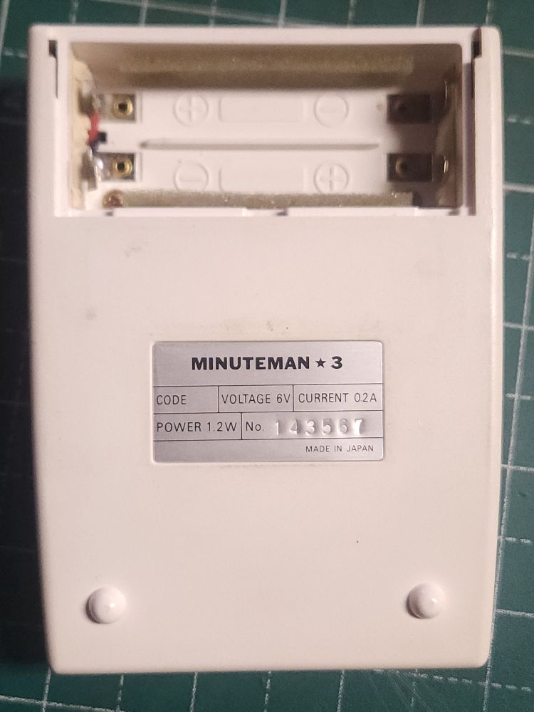 Back of the calculator with label and battery compartment open.