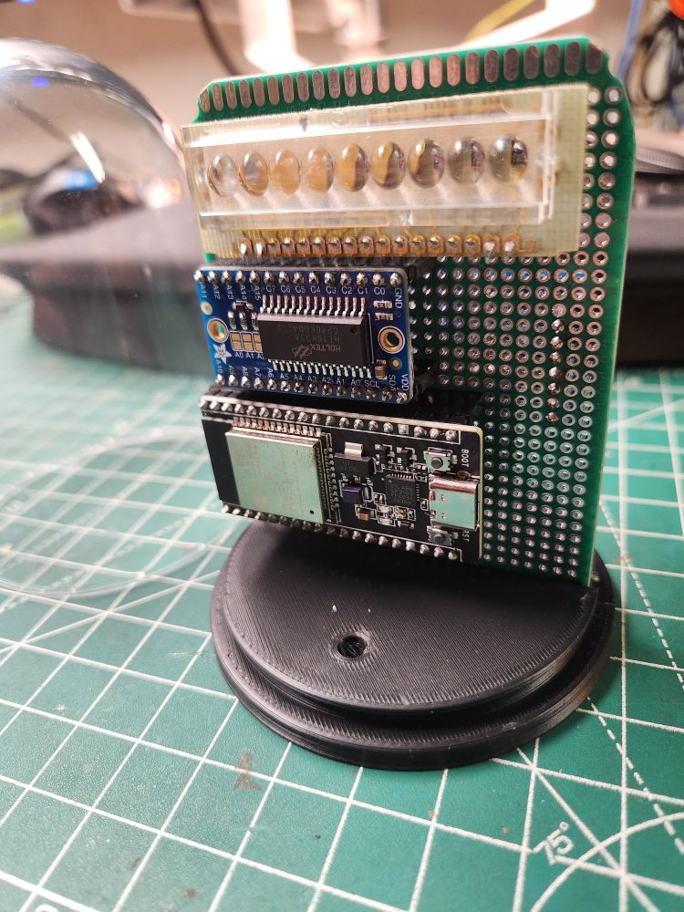 A prototype of a clock with 1970s bubble LED display this time with glass dome removee. Visible ESP32 board and HT16K33A breakout board.