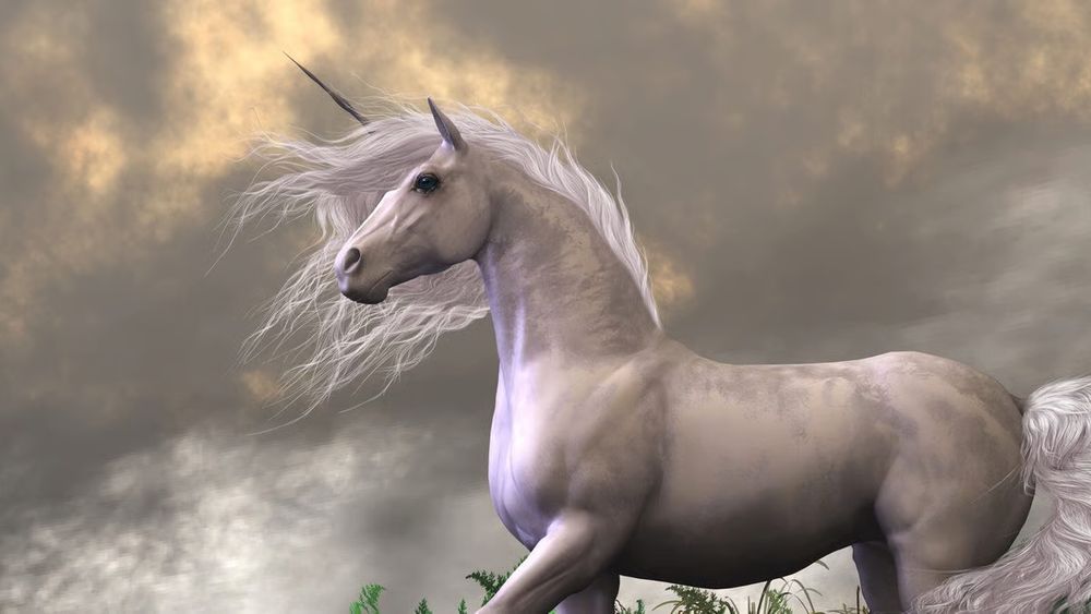 A unicorn stands with it's back to the wind, it's flowing mane sweeping forward with dark clouds above it.