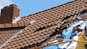 Image shows a damaged roof on a house