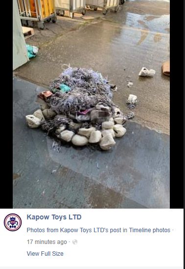 the linked facebook post, which shows a photo of a trash/cord pile in a flooded kapow toys warehouse with no caption.