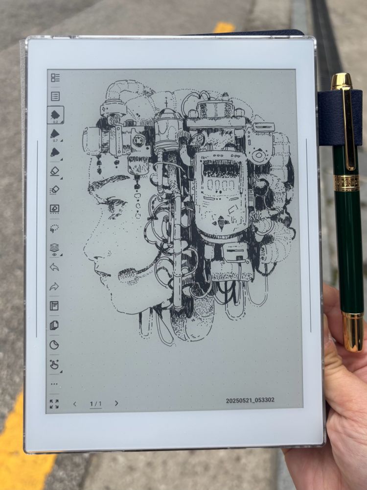 holding a kindle like device with a drawing of a woman’s side profile with mech over her hair/helmet