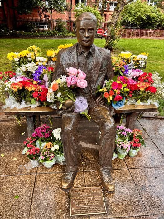 The Alan Turing Memorial, situated in Sackville Gardens in Manchester, England. (Just outside Manchester's gay village.) It is a bronze sculpture in memory of Alan Turing, a pioneer of modern computing. Alan is sitting on bench. The memorial is covered in flowers, as it is his birthday today. 
