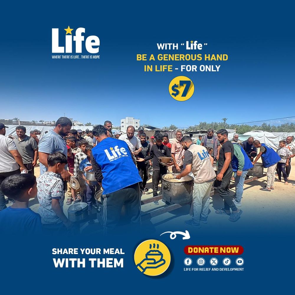 A group of volunteers wearing blue and beige vests labeled “Life” serve large pots of food to a crowd of men and children gathered outdoors under a bright sky. People wait with containers in hand, forming lines near tents in the background. Text overlay reads: "With 'Life' Be a generous hand in life – for only $7. Share your meal with them. Donate now."
