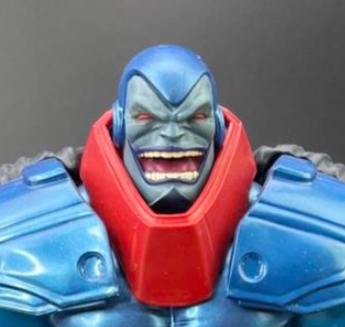 an apocalypse action figure smiling up close