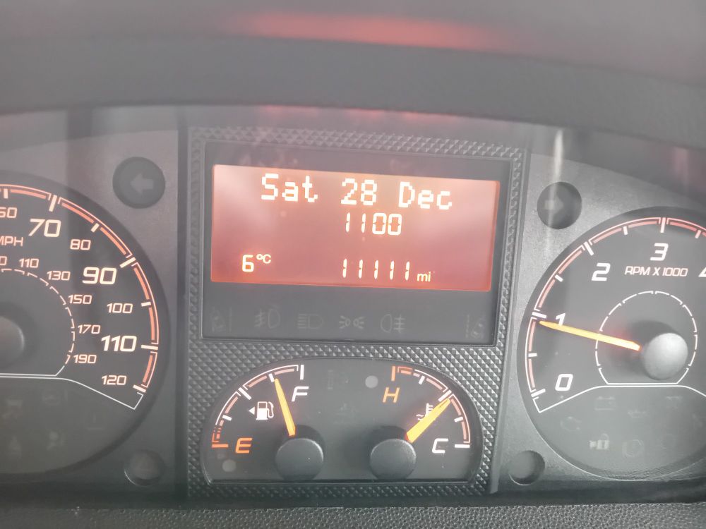 Photo of campervan dashboard showing mileage as 11111 miles 11.00am.