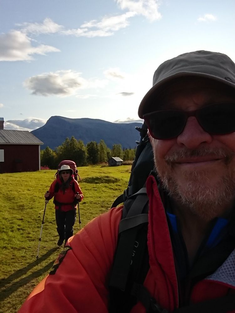 Men facing camera, hiking in Arctic Sweden, followed by Chrissie 