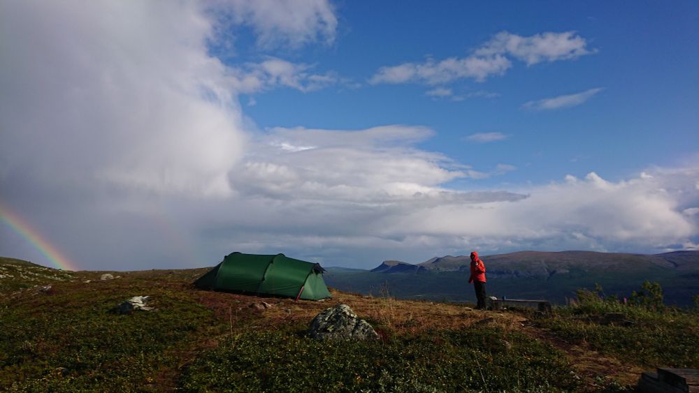 Chrissie, our tent and a rainbow on a high mountain pass in Arctic Sweden. 