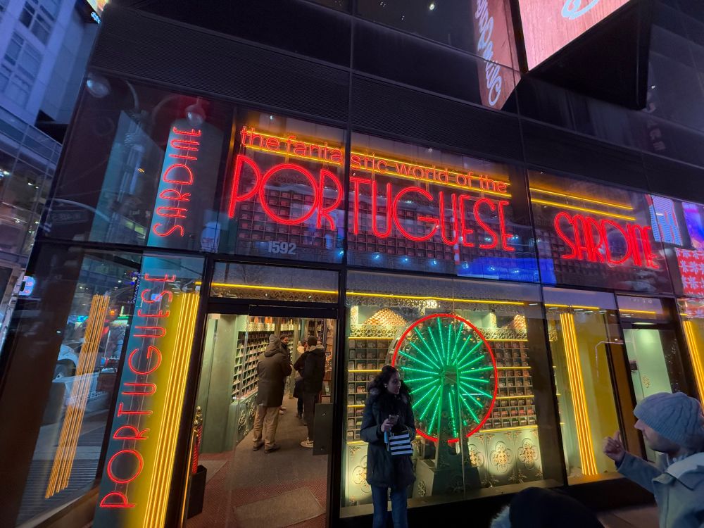 Nighttime storefront of “the fabulous world of Portuguese Sardine”