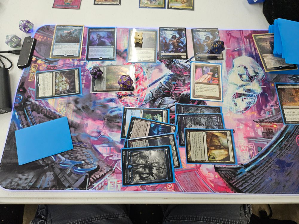 A board state of a zombie token commamder deck lesd by Gisa, the Hellraiser and Geralf, the Fleshwright. Of note, 13x 15/15 menace zombie tokens.