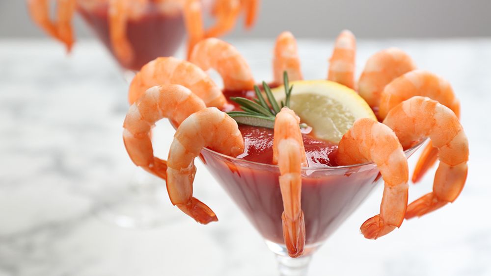 Shrimp cocktail in a martini glass with garnish