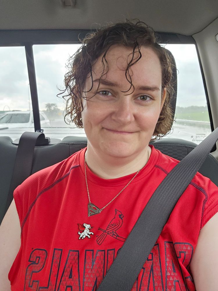 Selfie of Alanna with visibly wet hair in the car after leaving the game early due to torrential downpour. The rain really made her S curl pop!