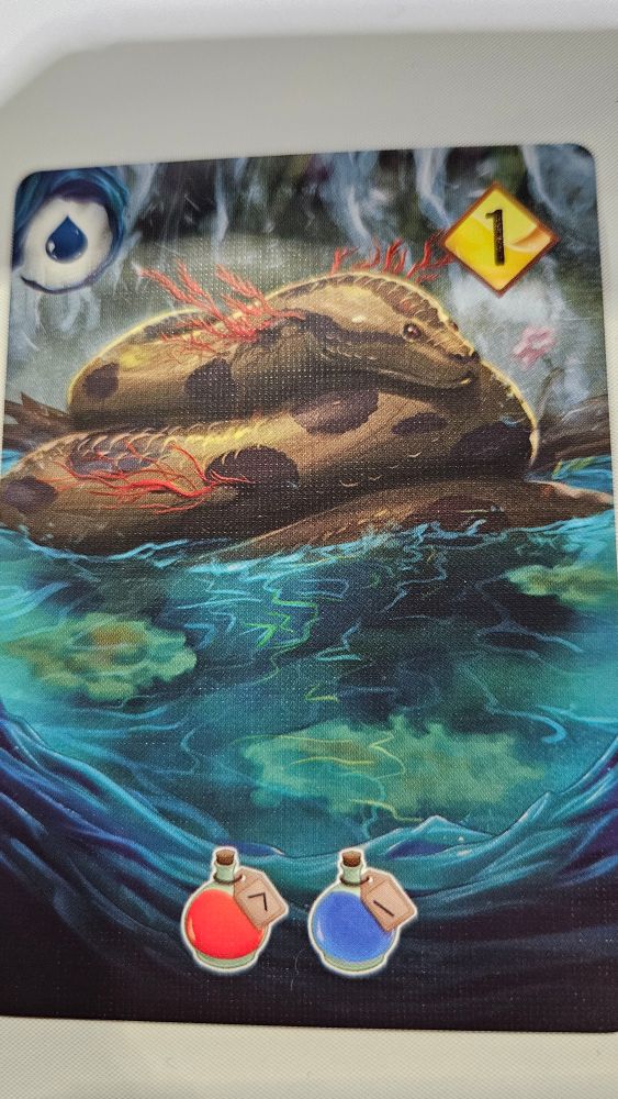 A card from Parks and Potions. A constrictor snake with coral growing on it.