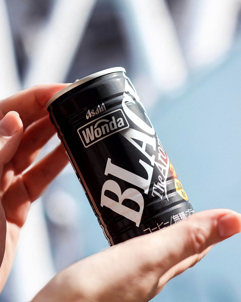 A can of Asahi Wonda Black in front of the Tokyo Skytree by day