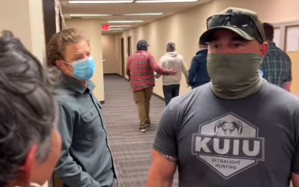 Masked ICE agent at Seattle Immigration Court this week as a man who sought asylum is taken away by other masked ICE agents