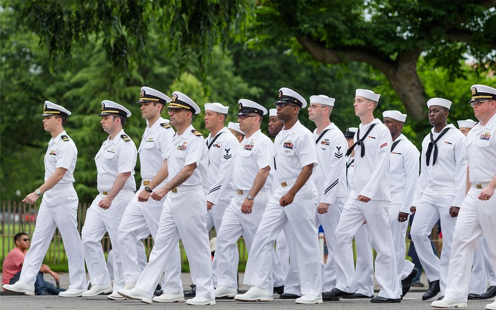 Group of U.S. Navy sailors marching into town